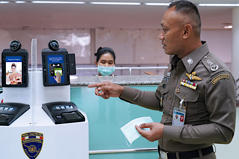 Thai Immigration Bureau deputy commissioner Pol Maj-Gen Surapong Chaichan demonstrates the new fever detection system at Don Mueang International Airport in Bangkok.